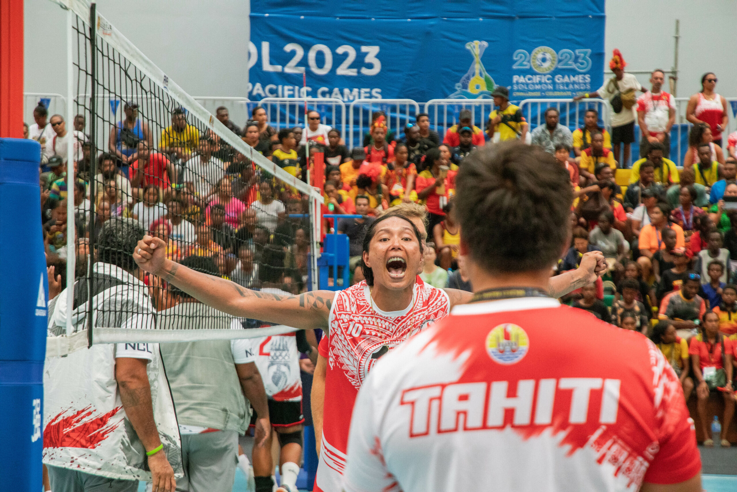A female volleyball player celebrating victory