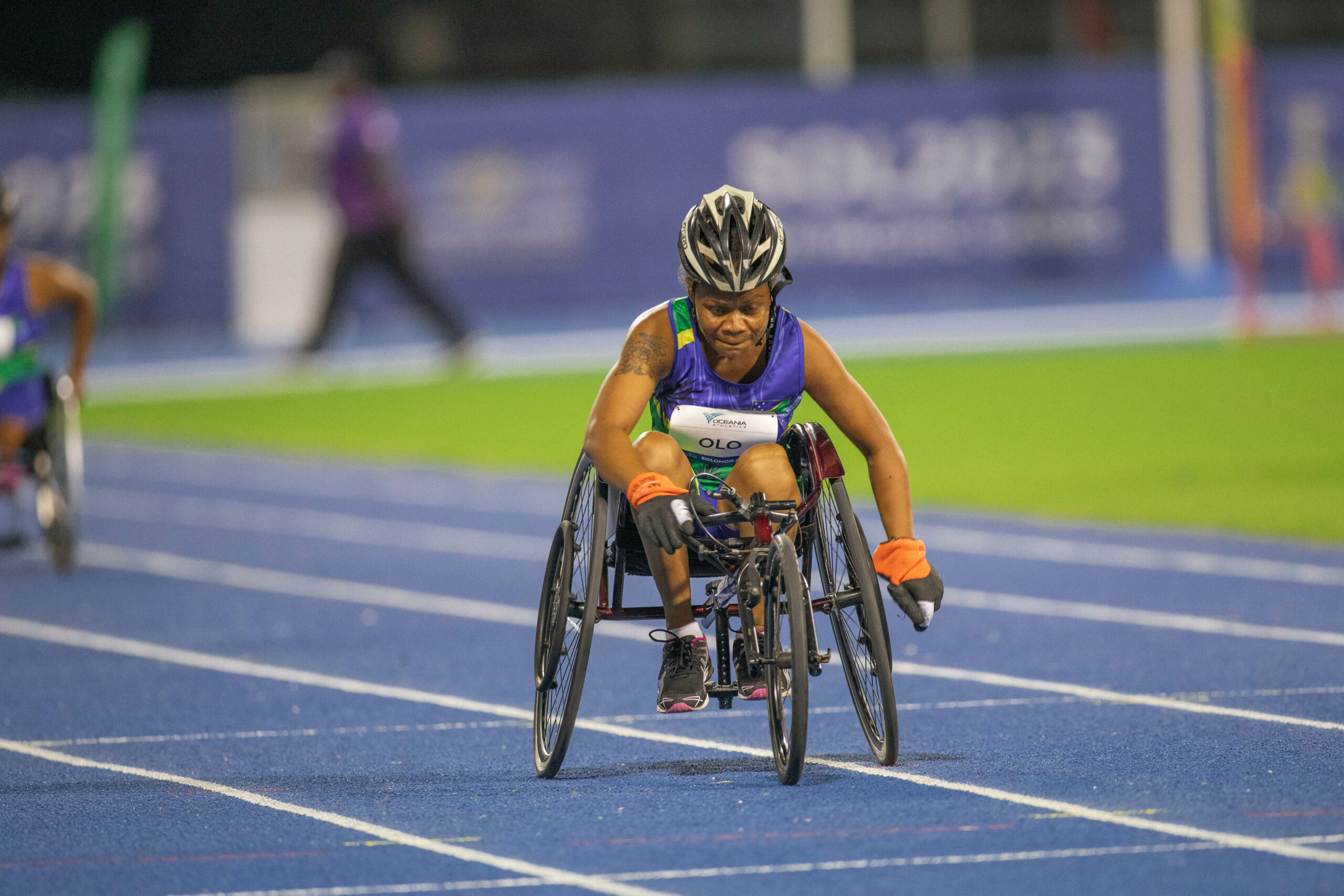 A woman racing in a wheelchair