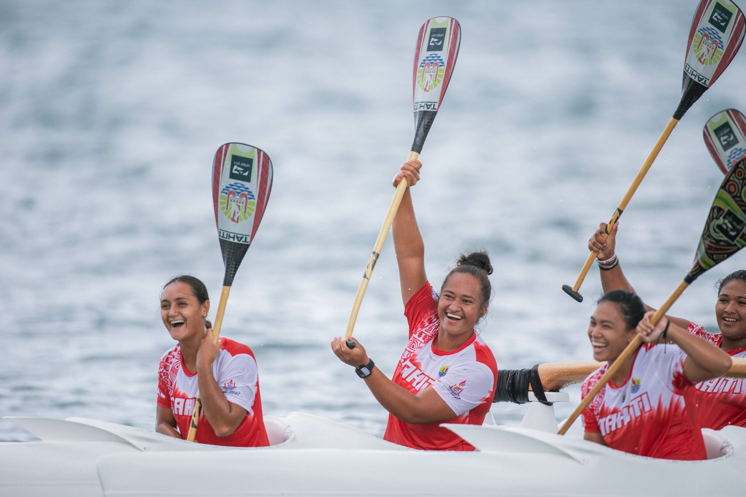 Women paddling an outrigger canoe in a race