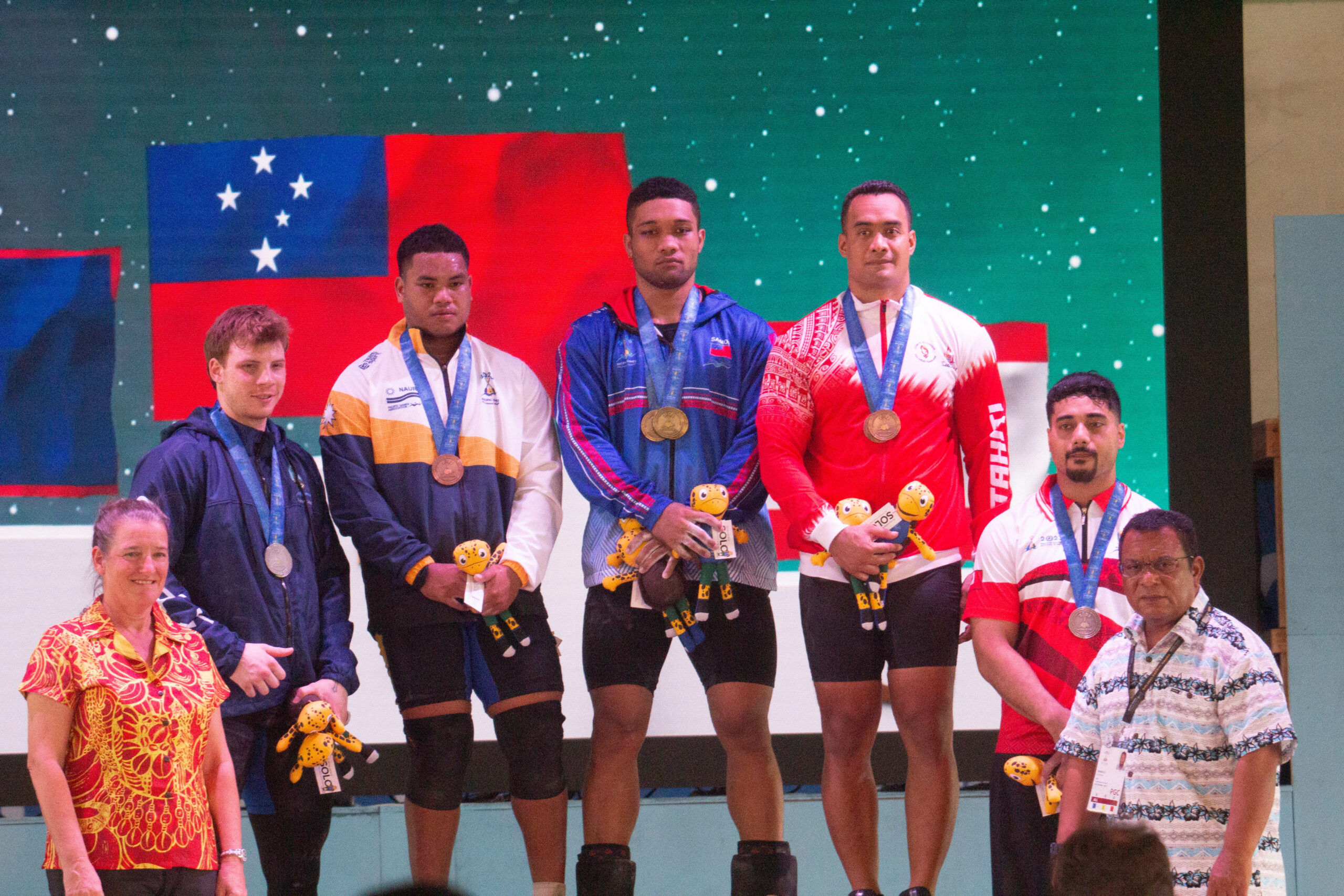 Male weightlifters at a medal ceremony
