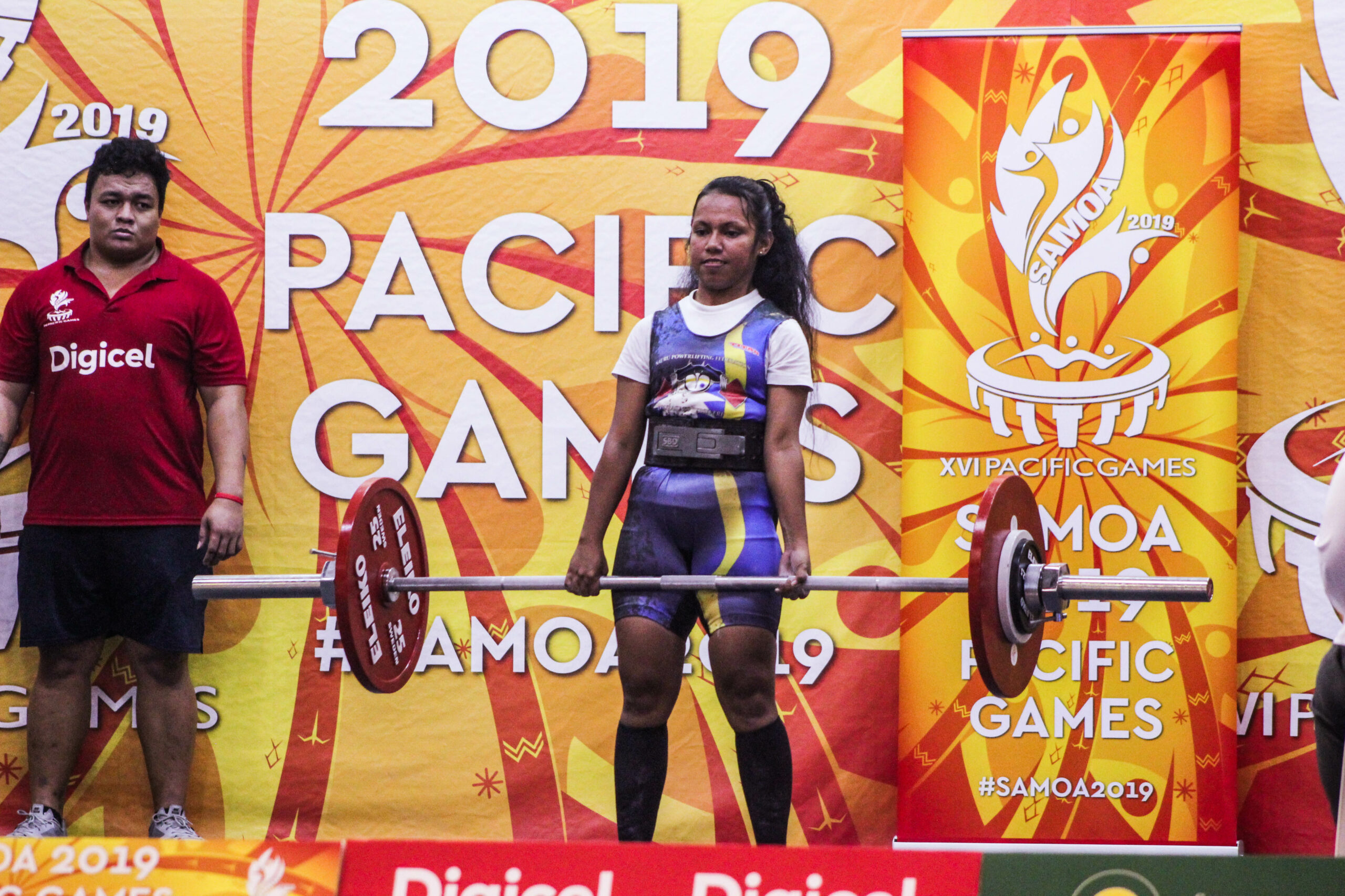 A woman competing in powerlifting