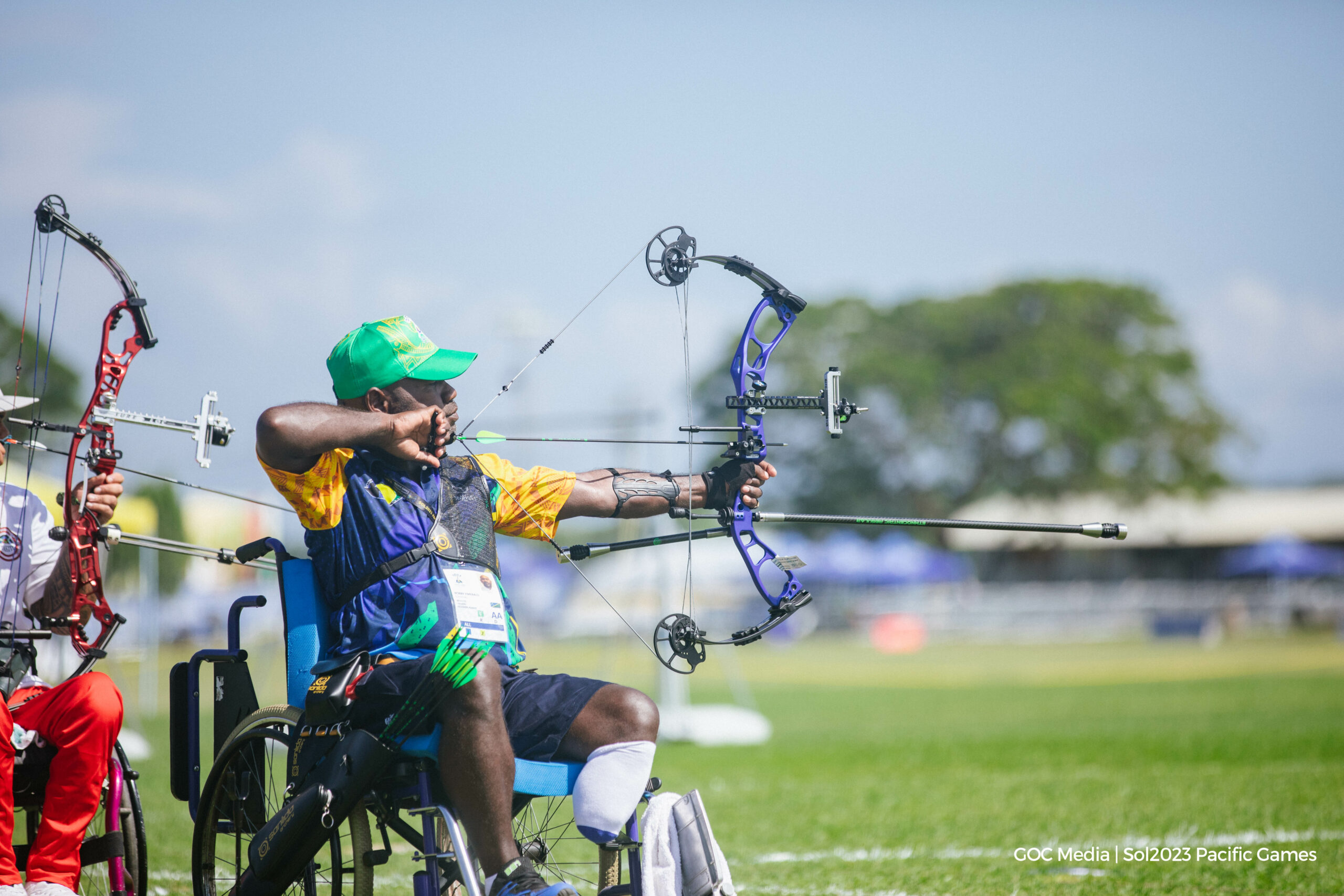 A man in a wheelchair competing in archery