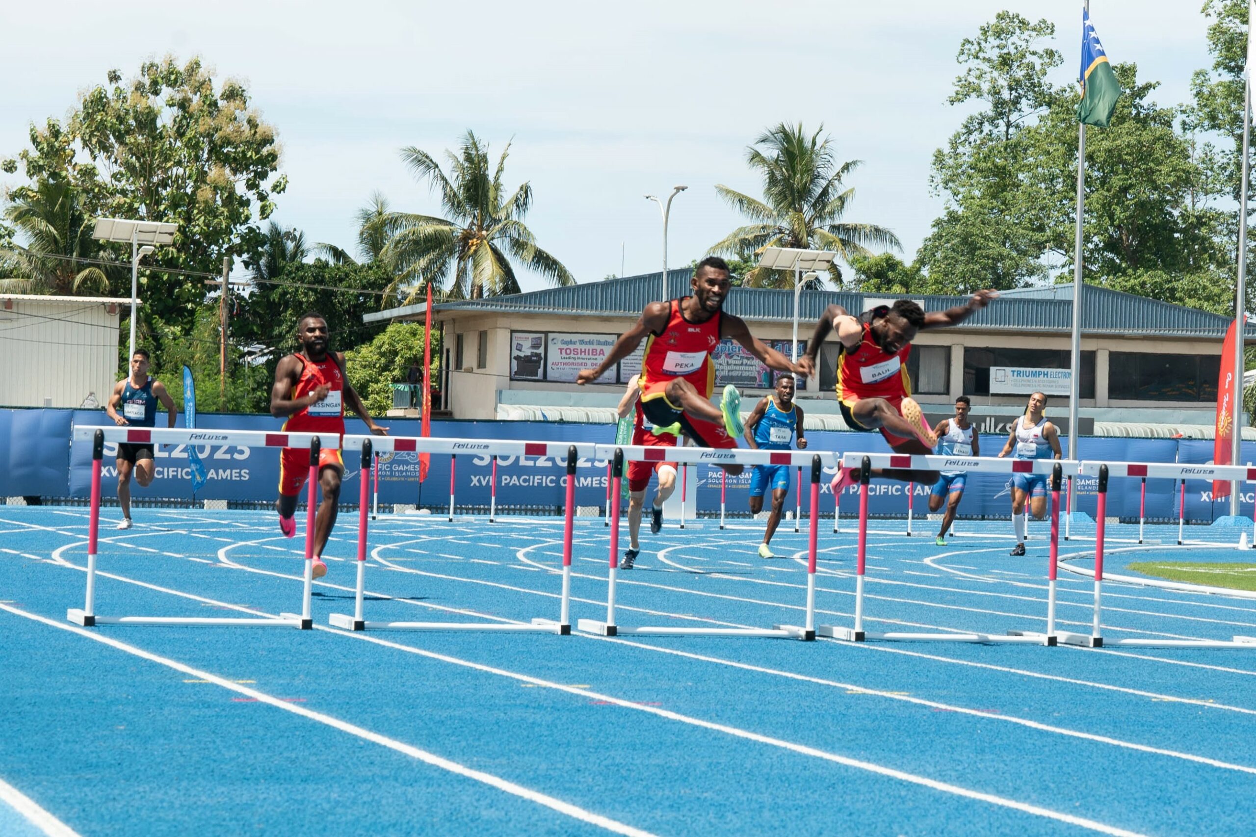 Men running a hurdles race